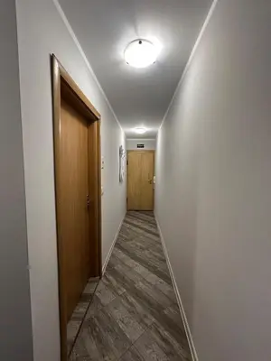 an empty hallway with a door and a hallwayngth at Tanov Cozy Place in Blagoevgrad