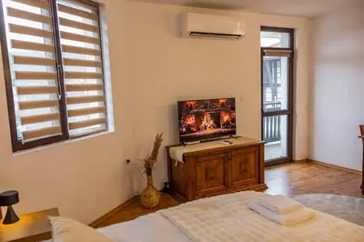 a bedroom with a bed and a flat screen tv at Flat in Bansko 5m walk to gondola in Bansko