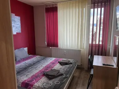a small bedroom with a bed and a desk at Heart of Pernik apartment 2 in Pernik