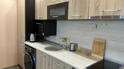 a kitchen with a sink and a microwave at Heart of Pernik apartment 2 in Pernik