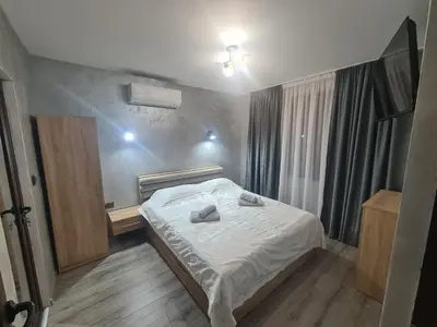 a bedroom with a bed with two towels on it at Къща за гости Джерман Guest house Dzherman in Sapareva Banya