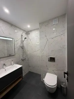 a bathroom with a toilet and a sink at DomBox Sofia Suites - Stylish 2 Bedroom in Center - Free Garage in Sofia