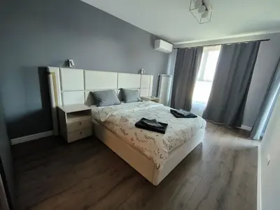 a bedroom with a large bed and a window at DomBox Sofia Suites - Stylish 2 Bedroom in Center - Free Garage in Sofia