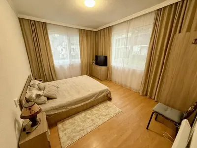 a small bedroom with a bed and a television at Guest House Mihalkovo in Mikhalkovo
