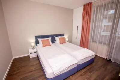 a bedroom with a large bed and a window at Saphi Apt in Sandanski