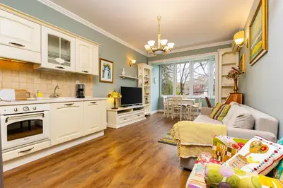 a kitchen and living room with a couch and a table at 1BR Apartment in the Center with Free Street Parking and Designated Workspace in Plovdiv