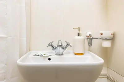 a bathroom sink with a soap dispenser on it at 1BR Apartment in the Center with Free Street Parking and Designated Workspace in Plovdiv