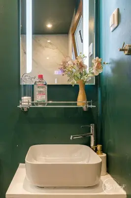 a bathroom with a sink and a vase with flowers at Namaste apartment - cozy, central and relaxing stay near AUBG, freshly renovated in Blagoevgrad