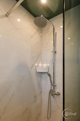 a shower with a glass door in a bathroom at Namaste apartment - cozy, central and relaxing stay near AUBG, freshly renovated in Blagoevgrad