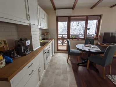 a kitchen with a table and a dining room table at Lovely 1-bedroom Apartment with Mountain View in Bansko