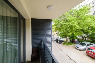 a balcony of a building with cars parked on the street at Quiet & Comfy 1BR in the Heart of Plovdiv with Private Balcony in Plovdiv