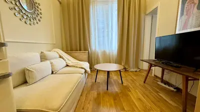 a living room with a couch and a flat screen tv at 2 Bedrooms Top Central Apartment on Vitosha Boulevard in Sofia