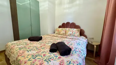a bedroom with a bed with two towels on it at 2 Bedrooms Top Central Apartment on Vitosha Boulevard in Sofia
