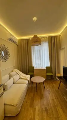 a living room with a couch and a table at 2 Bedrooms Top Central Apartment on Vitosha Boulevard in Sofia