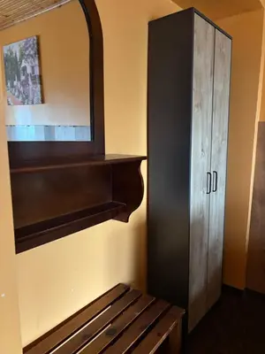 a mirror and a wooden bench in a room at Парк-хотел Родопи in Churen