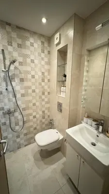 a bathroom with a shower and a toilet and a sink at Brand New Luxury Apartments with Great Views in Sofia