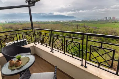 a balcony with a table and chairs and a view at Brand New Luxury Apartments with Great Views in Sofia