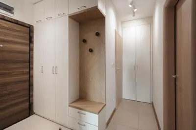 a walk in closet with white cabinets and a wooden door at Brand New Luxury Apartments with Great Views in Sofia