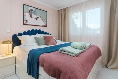 a bedroom with a blue and white bed and a window at Maison Colorée - Bright And Cozy Home by Metro And Mall in Sofia