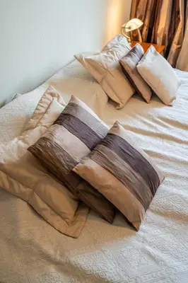 a pile of pillows sitting on top of a bed at Elegant Aristocratic 2 BDRM Flat, TOP Location in Sofia