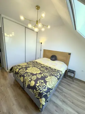 a bedroom with a bed with a black and white blanket at Cozy Home In Central Plovdiv in Plovdiv