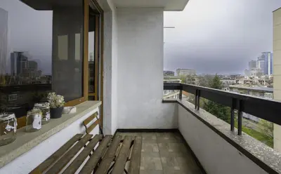 a balcony with a bench and a view of a city at The Cosmopolitan Shine 1-BDR Pet-Friendly Flat in Sofia