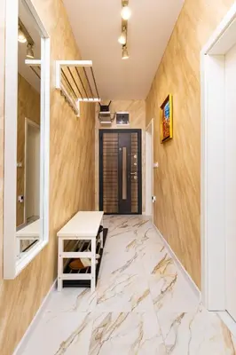 a hallway with marble flooring and wooden walls at Serene Living in the Heart of Plovdiv by Flat Mаnager in Plovdiv