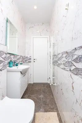 a bathroom with a white sink and a mirror at Serene Living in the Heart of Plovdiv by Flat Mаnager in Plovdiv