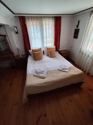 a bedroom with a bed with two towels on it at Mountain View ECOVILLA in Devin