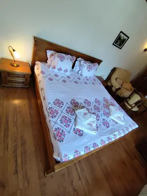 a bedroom with a bed with white sheets and pillows at Mountain View ECOVILLA in Devin