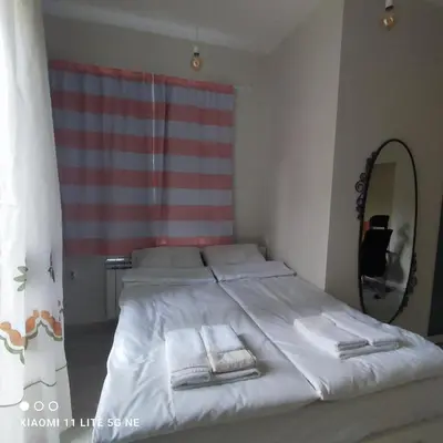 a bedroom with a bed with two towels on it at NDK Central Home in Sofia