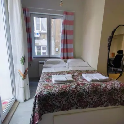 a bedroom with two beds and a window at NDK Central Home in Sofia