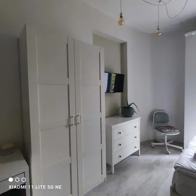 a bedroom with a white cabinet and a dresser at NDK Central Home in Sofia