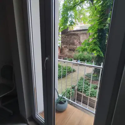 a window with a view of a garden at NDK Central Home in Sofia