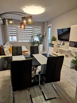 a dining room and living room with a table and chairs at Apartamento Estrella in Sofia