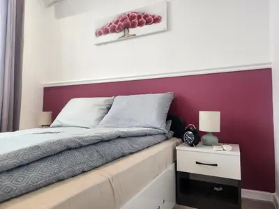 a bedroom with a purple accent wall and a bed at luxury Apartament TD one bedroom in Sofia