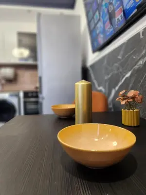 a wooden table with two bowls on top of it at luxury Apartament TD one bedroom in Sofia
