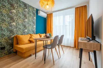 a living room with a couch and a table at Exotic apartment in Sofia