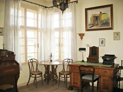 a room with a table and chairs and a window at Apartment Mariza in Plovdiv