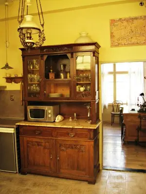 a kitchen with a wooden cabinet with a microwave at Apartment Mariza in Plovdiv