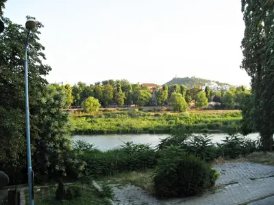 a view of a river with trees and a street light at Apartment Mariza in Plovdiv