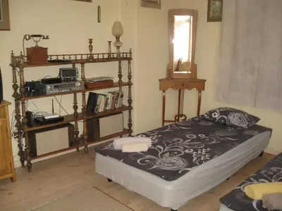 a bedroom with a bed and a shelf with books at Apartment Mariza in Plovdiv