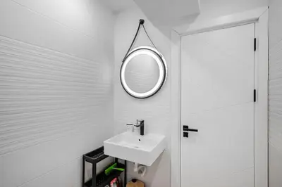a white bathroom with a sink and a mirror at AeroLuxe Living 1BD Apartment by Flat Mаnager in Sofia