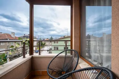 a balcony with a chair and a large window at AeroLuxe Living 1BD Apartment by Flat Mаnager in Sofia
