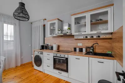a kitchen with white cabinets and a sink and a dishwasher at AeroLuxe Living 1BD Apartment by Flat Mаnager in Sofia