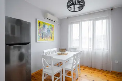 a white dining room with a white table and chairs at AeroLuxe Living 1BD Apartment by Flat Mаnager in Sofia