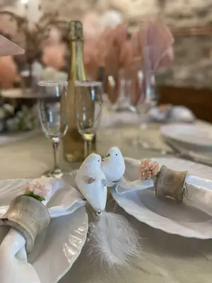 a table with a plate with two birds on it at Вила Китна in Lozno