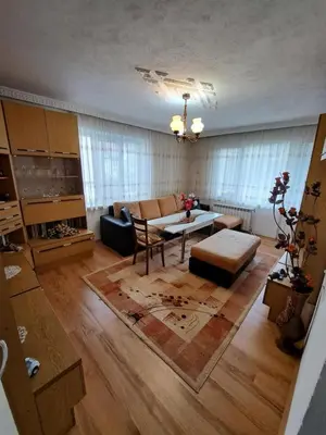 a living room with a table and a couch at Къща за гости ЖАНИ in Zmeitsa