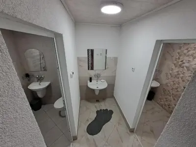 a bathroom with a sink and a mirror at Къща за гости ЖАНИ in Zmeitsa