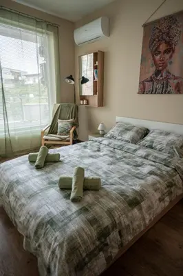 a bedroom with a large bed with two pillows on it at Boho Floral Apartment near to Old Town in Plovdiv